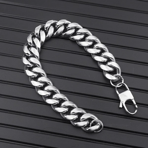 Detail of silver stainless steel Cuban link chain necklace with polished lobster clasp