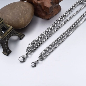 Detail of four stainless steel chain styles including wheat and box links with lobster clasps