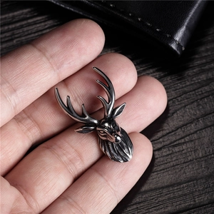 Macro shot of retro silver stag deer pendant with detailed antique finish and antlers