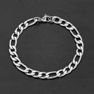 Close-up of polished silver Figaro chain bracelet with lobster clasp on dark background