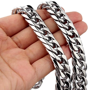 Close-up of hand holding thick polished stainless steel Cuban link chain necklace