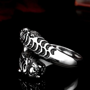 Detailed macro view of vintage silver double tiger heads ring with oxidized punk finish