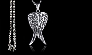 Close-up of vintage silver wing heart pendant with sturdy steel box chain on black background