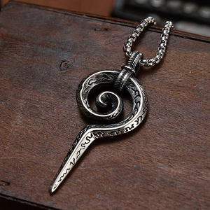 Macro detail of vintage punk snake scepter pendant with textured stainless steel finish