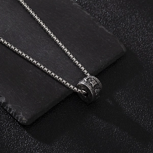 Vintage oxidized silver spinning cylinder necklace with Buddhist mantra on black rock