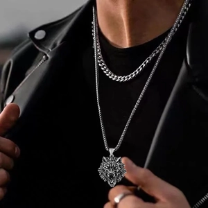 Close-up of double-layer silver wolf head pendant necklace on model with black leather jacket