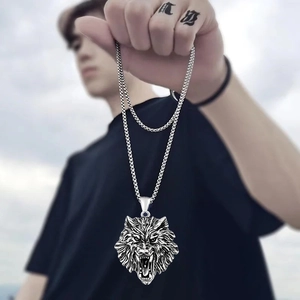 Detailed close-up of a vintage wolf head pendant in oxidized stainless steel for men