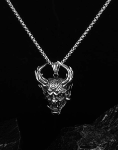 Detailed close-up of a vintage silver Hiphop Oni mask pendant with a box chain necklace