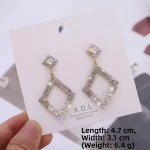 Detail view of double diamond-shaped S925 silver stud earrings with glittering zircons