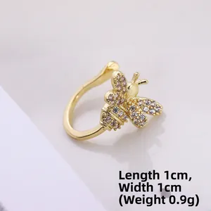 Macro detail of a 1cm golden bee ear cuff with sparkling cubic zirconia wing stones