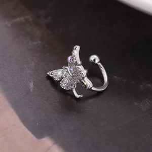 Sparkling butterfly ear cuff with zircon inlays on a polished silver metal base