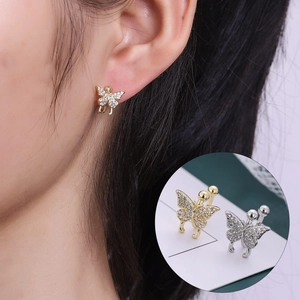 Detail view of butterfly ear cuff with sparkling zircons worn on a model's ear