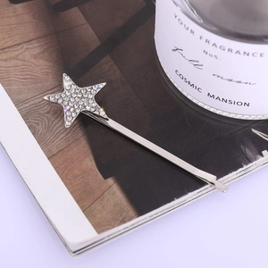 Elegant silver star hair clip with sparkling rhinestones on minimalist metal bobby pin