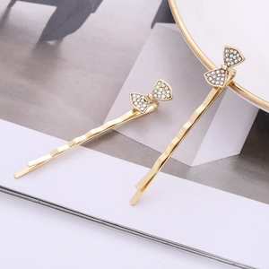 Set di fermagli per capelli a fiocco dorato con strass iridescenti e design ondulato