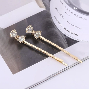 Eleganti fermagli per capelli dorati a forma di fiocco con strass brillanti