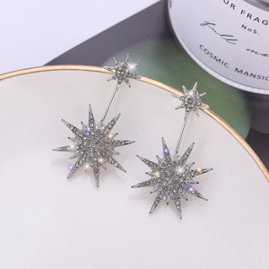 Sparkling S925 silver star stud earrings with white zircons on a white ceramic plate