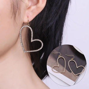 Macro shot of large hollow heart drop earrings featuring sparkling full pavé rhinestones