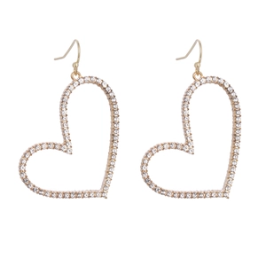 Fashionable gold heart dangle earrings with white rhinestones on white background