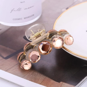 Elegant clear acrylic hair claw clip with champagne crystals and golden metal spring
