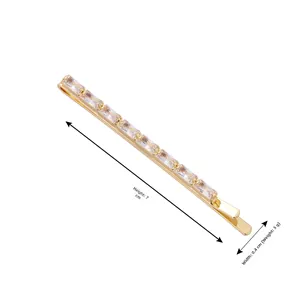 Detail view showing a 7cm gold hair clip with sparkling rectangular cubic zirconia stones