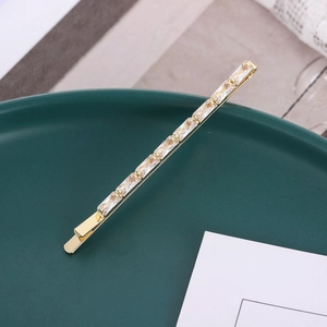 Elegant gold alloy hair clip featuring rectangular cubic zirconia in a minimalist design