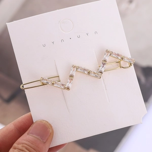 Elegante fermaglio per capelli dorato a forma di S con strass rettangolari per donne