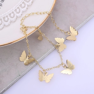 Golden butterfly charm anklet with textured metal pendants and adjustable clasp link chain