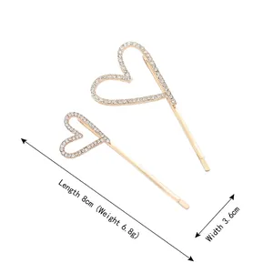 Baroque style gold heart hair clips with rhinestones, 8cm length on white background