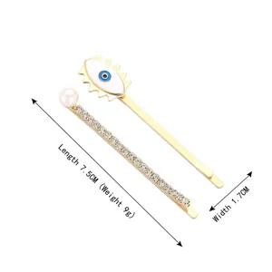 Pasador dorado con diseño de ojo azul, perlas y brillantes para el cabello