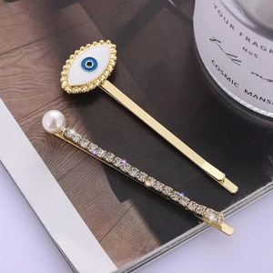 Golden hair clip set with blue evil eye design, sparkling rhinestones and white pearl