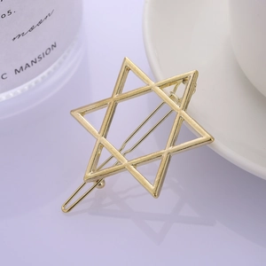 Elegant gold minimalist hexagram star hair clip on a soft purple background display