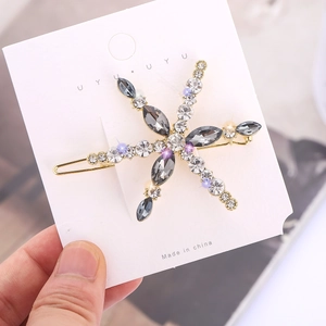 Elegant rhinestone snowflake hair clip with gold metal base and sparkling crystals