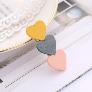 Minimalist wood heart hair clip with yellow grey and pink geometric design for women