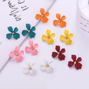 Floral stud earrings in multiple colors with matte finish and gold centers on white background