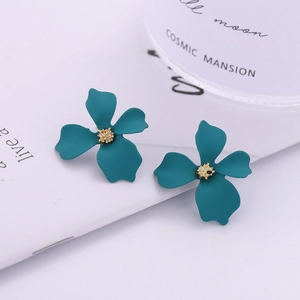 Elegant matte dark teal flower stud earrings with golden stamens in a minimalist style