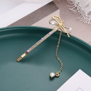 Pince à cheveux dorée élégante avec nœud en strass et pompon à pendentif cœur
