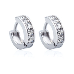 Detail of silver huggie earring featuring four square-cut clear cubic zirconia stones