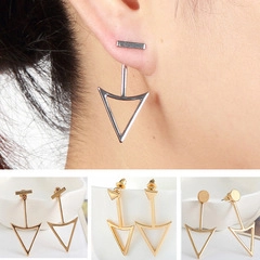 Detail view of vintage geometric dangle earrings with rhinestones in gold and silver finish