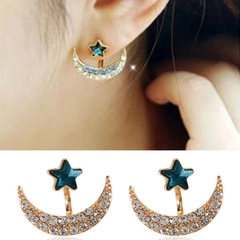 Detailed view of star and moon stud earrings featuring blue gems and white crystals