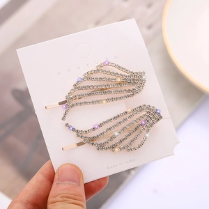 Ensemble de barrettes ailes élégantes avec strass brillants sur base en métal doré