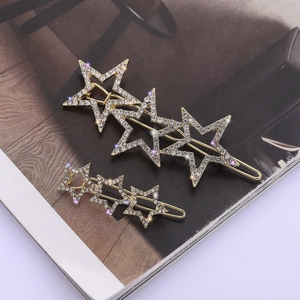 Sparkling gold star hair clip set with white rhinestones and elegant starry design