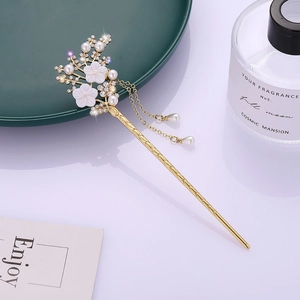 Elegant gold flower hair pin with white pearls, rhinestones, and double tassel charms