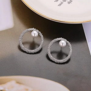 Minimalist C-shaped silver pearl earrings with matte texture and high-end design