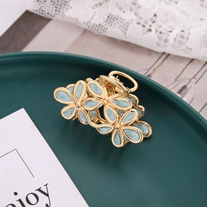 Elegant gold flower hair claw clip with light blue enamel petals for women hair styling