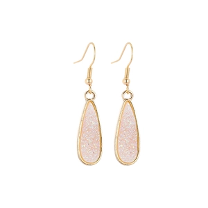 Detail of water drop earrings with pink glitter resin and golden metal frame