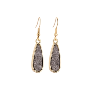 Detailed macro view of elegant grey druzy crystal teardrop earrings with gold plating