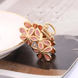 Pink enamel floral hair claw clip with golden alloy finish in a sweet Japanese style