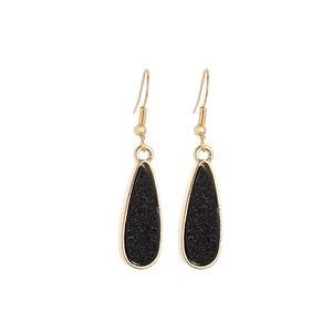 Minimalist black resin teardrop earrings with golden metal frame in a modern style