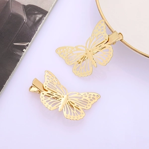 Elegant gold hollow butterfly hair clips with intricate metal texture on purple background