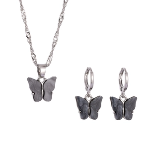 Detail of silver butterfly jewelry set with gray pearlescent marble texture resin inlays